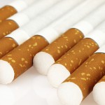 Cigarettes seen closeup lying on a light background.